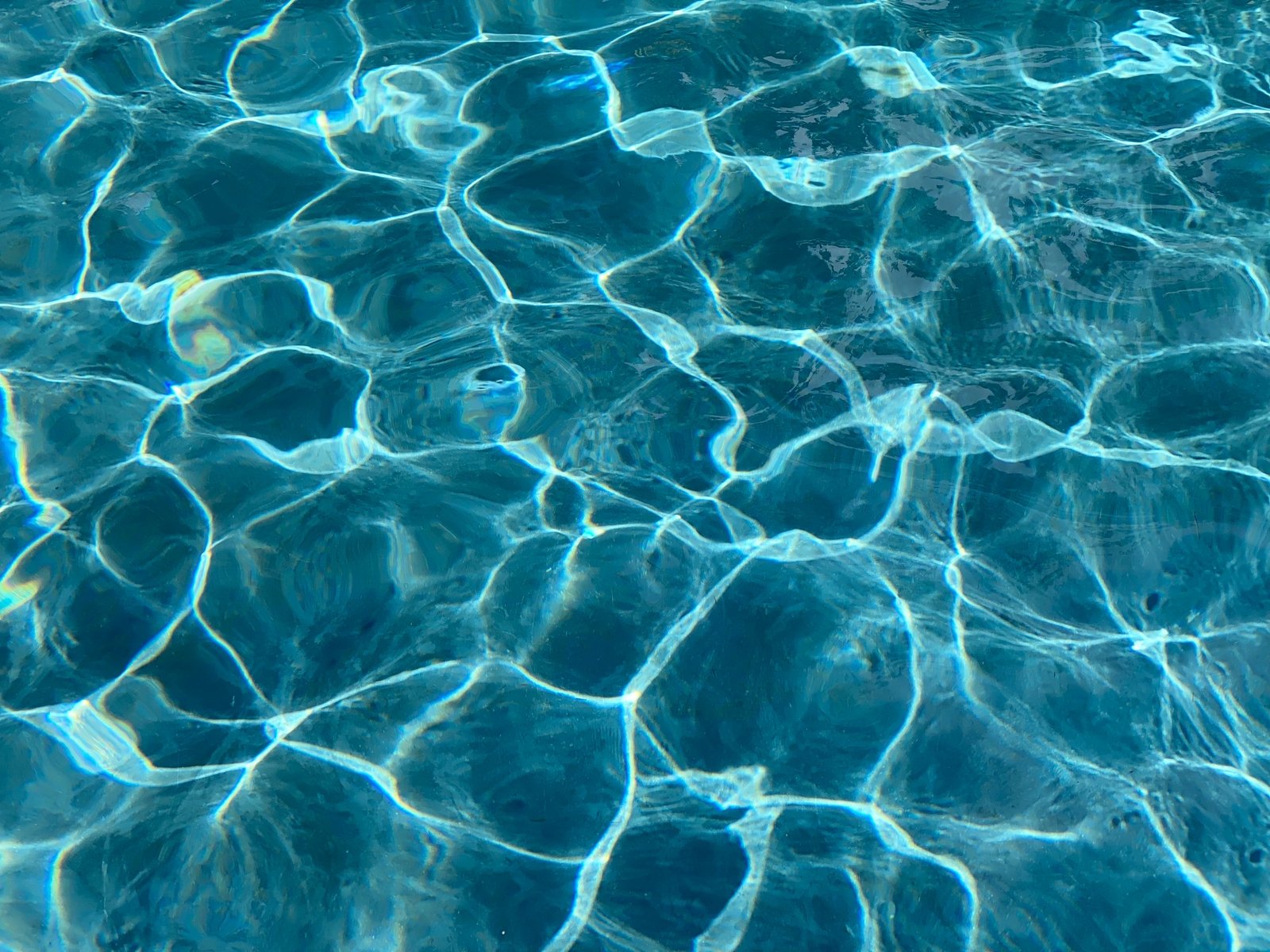 Blue Ripples and reflections in a swimming pool . Chlorine is in short supply during the pandemic.